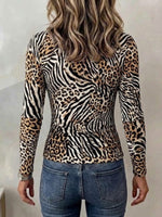 Ribbed Long-sleeve Knit Top Featuring A Leopard And Zebra Print Patchwork Design, Cut-out Details, And A Deep V-neck