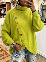 Jersey holgado de punto con cuello alto y fila diagonal de botones de colores