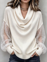 Elegante top in maglia con collo a lupetto e maniche in tulle trasparente